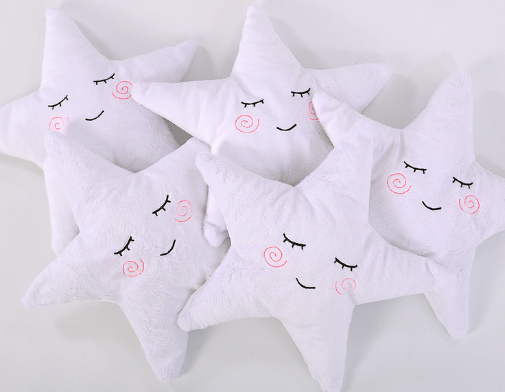 Star-shaped cuddle pillow with a rattle – white